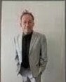 Tony Lawand as grey suit