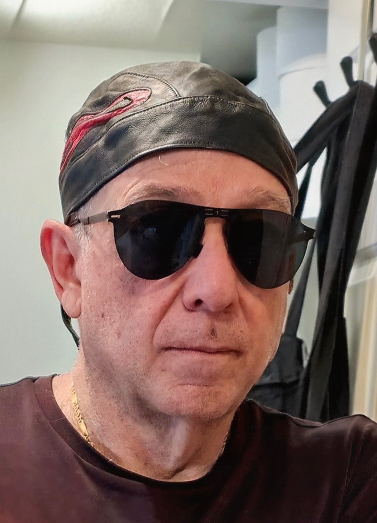 Tony Lawand in a leather skullcap and sunglasses