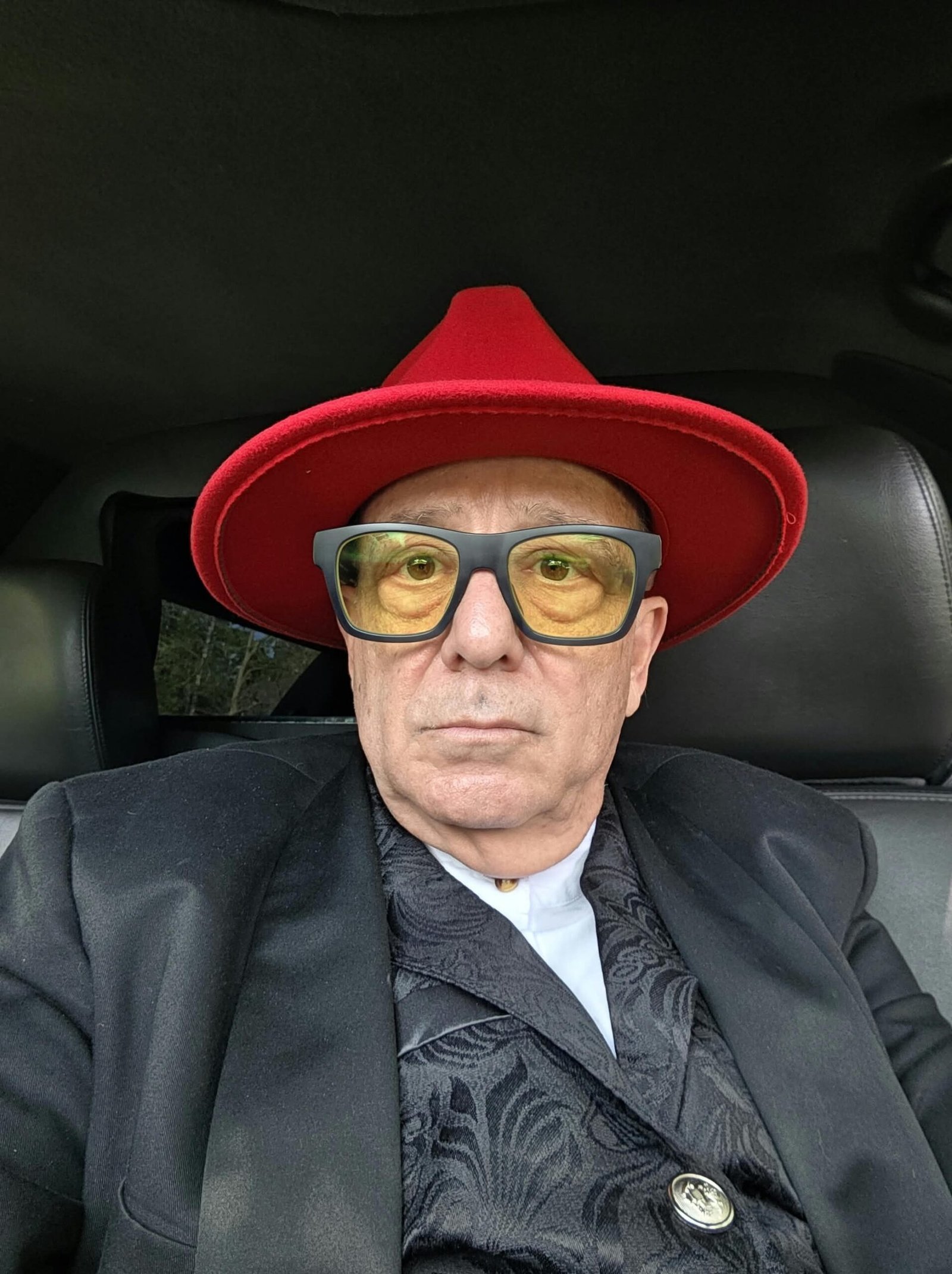 Tony Lawand in a red hat and yellow lenses behind the wheel